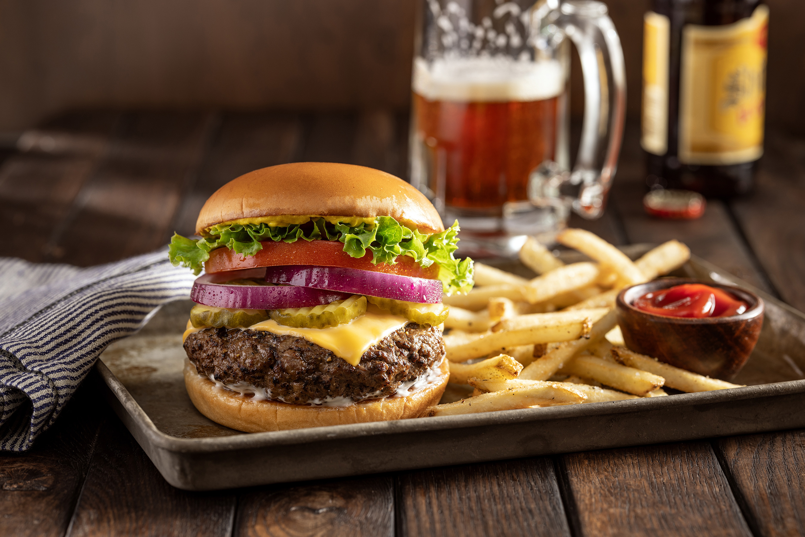 cheeseburger and french fries with cold beer by alyssa wernick food stylist styling dallas tx