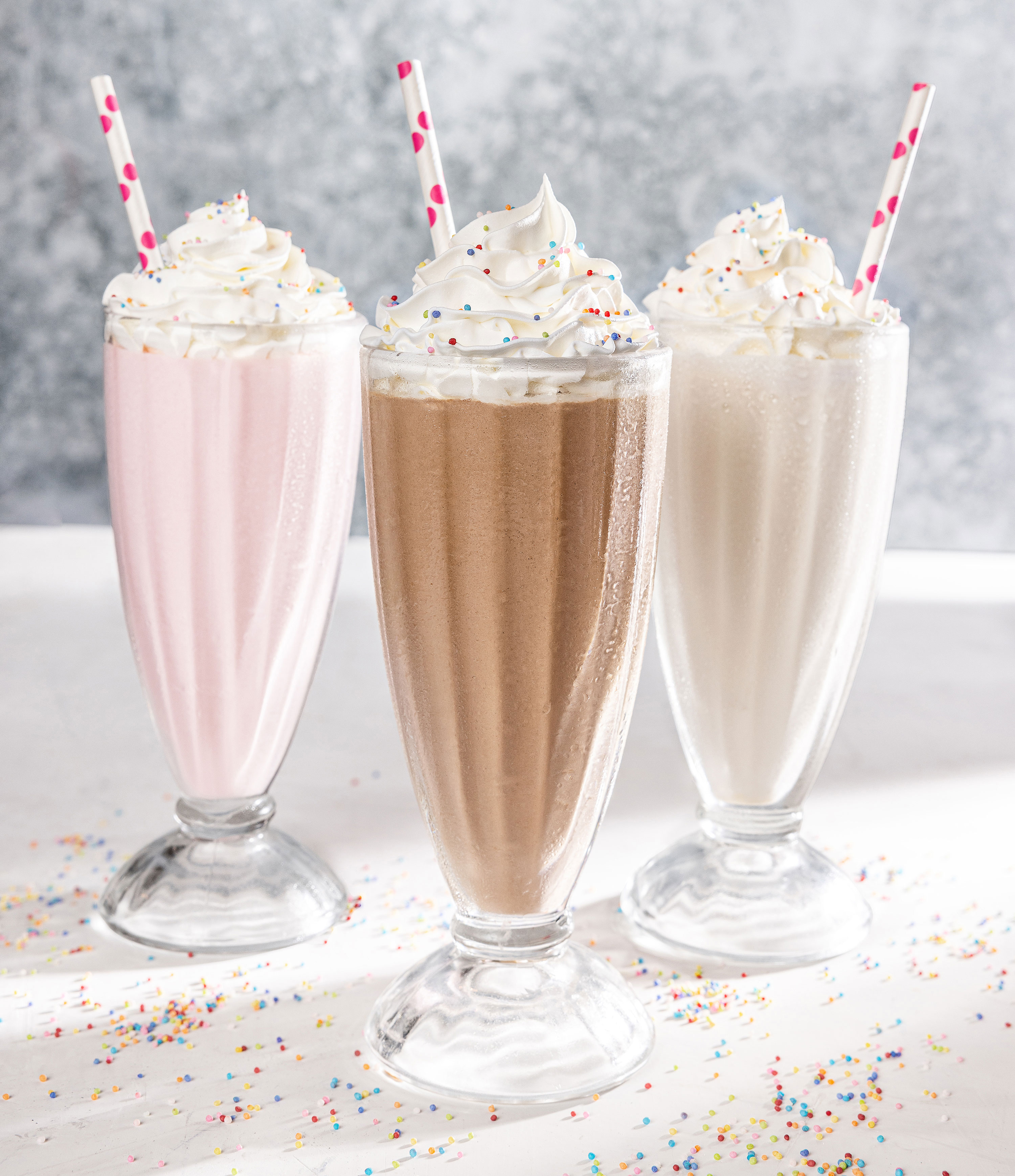 vanilla chocolate strawberry milkshakes with whipped cream and sprinkles alyssa wernick food stylist styling dallas tx food styling