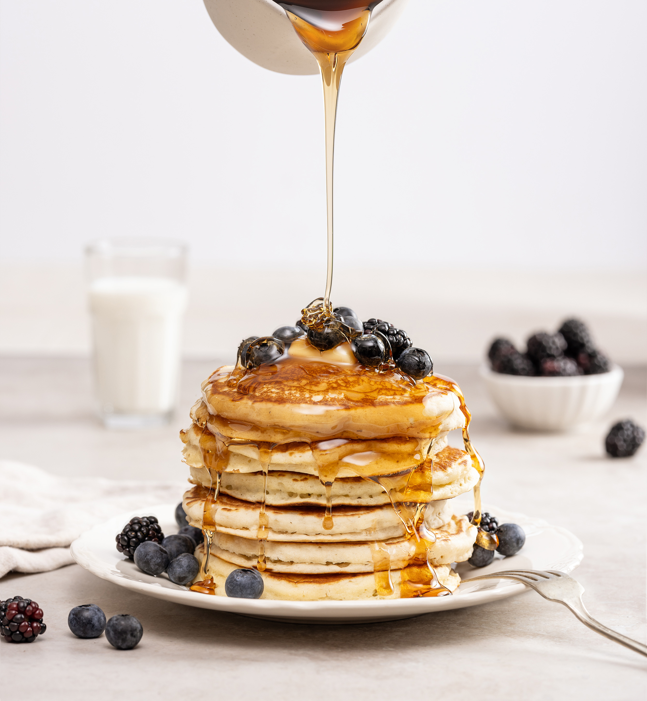stack of blueberry pancakes with syrup pour alyssa wernick food stylist styling dallas tx